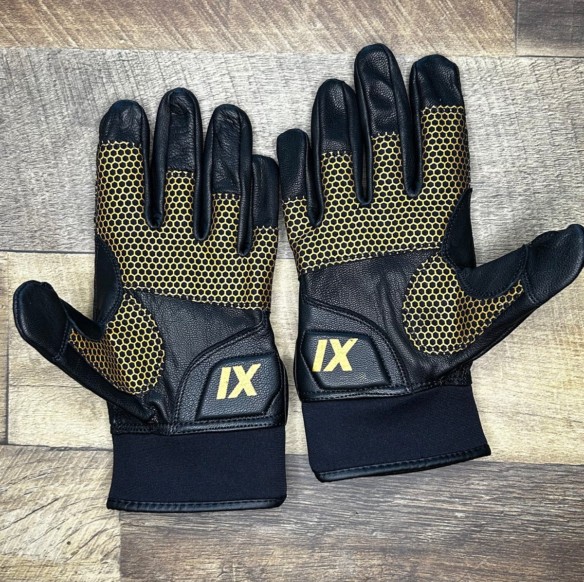 Palms of the IX Lions Genesis 1 batting gloves showing the gold Honeycomb Grip and IX logo on the heel