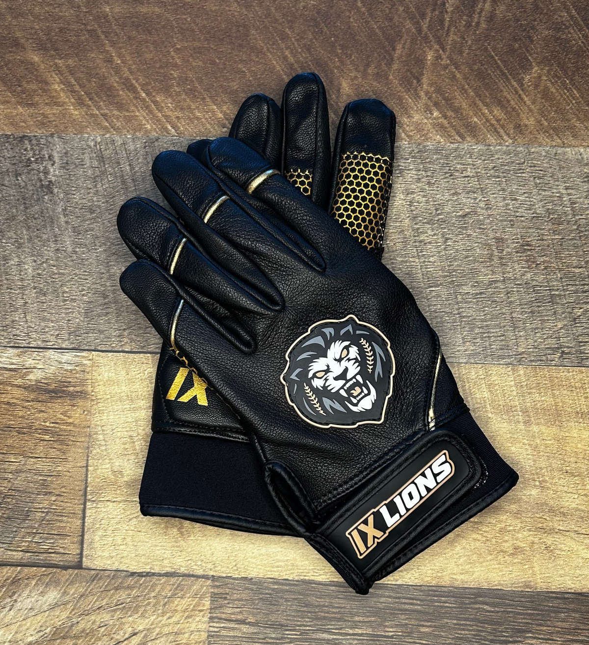 IX Lions Genesis 1 black batting gloves with lion crest on the back and IX Lions wrist strap