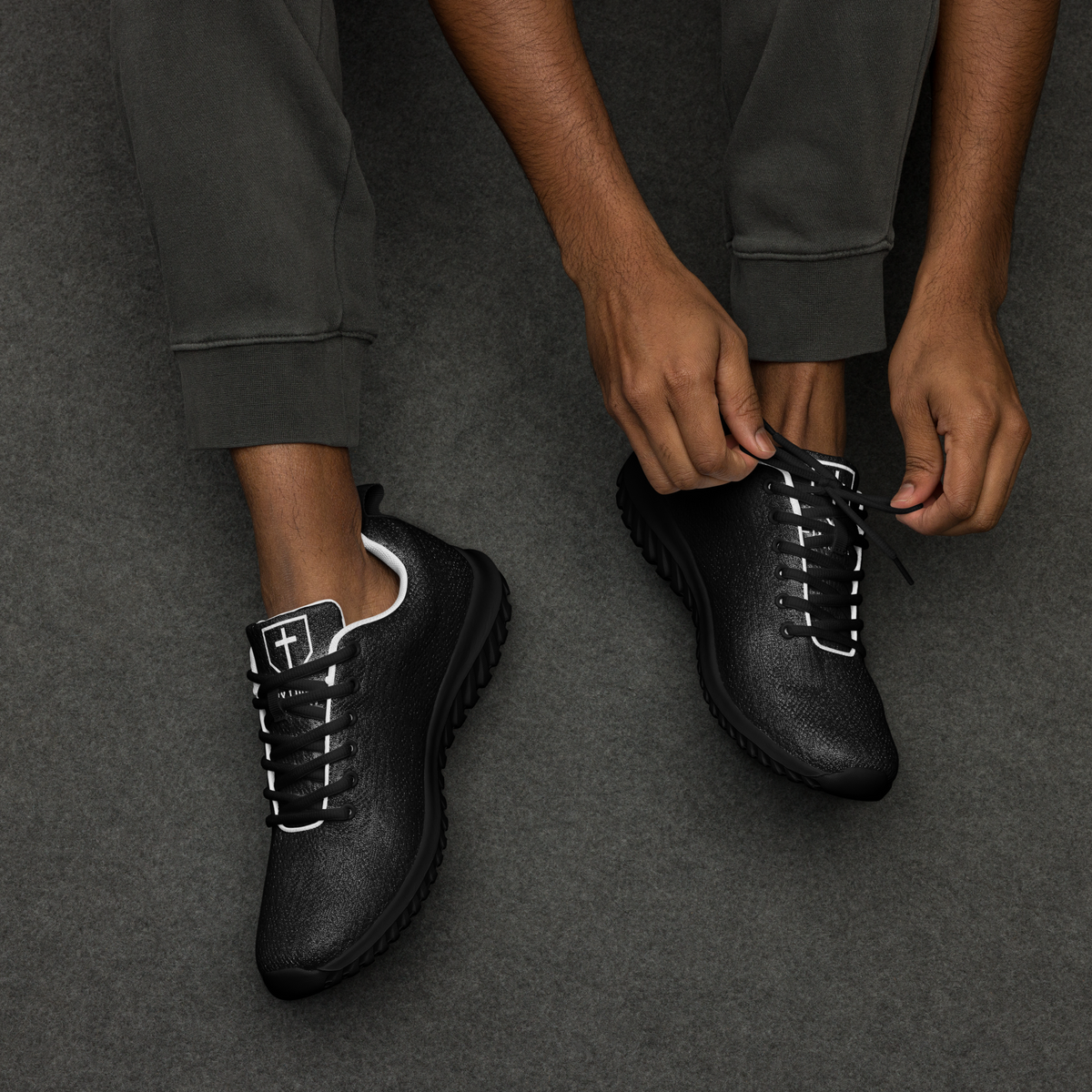 IX Lions Off-Field Trainers in black knit with cross logo on the tongue, pair