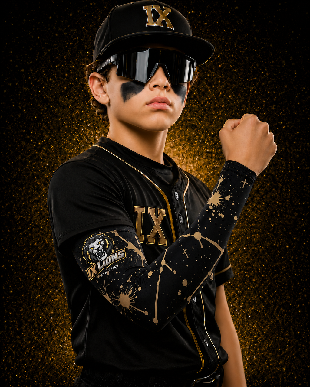 Young baseball player wearing IX Lions cap and showing off the Gold Splatter arm sleeve with lion crest patch